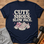 Navy t-shirt with "CUTE SHOES. SLOW PACE." text and pink sneakers graphic.