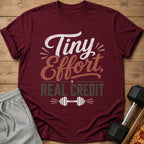 Maroon t-shirt with "Tiny Effort, REAL CREDIT" text and dumbbell graphic.