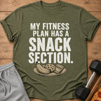Green t-shirt with white text "MY FITNESS PLAN HAS A SNACK SECTION." and snacks illustration.