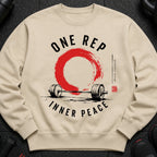 Light beige sweatshirt with "ONE REP INNER PEACE" text and barbell graphic.