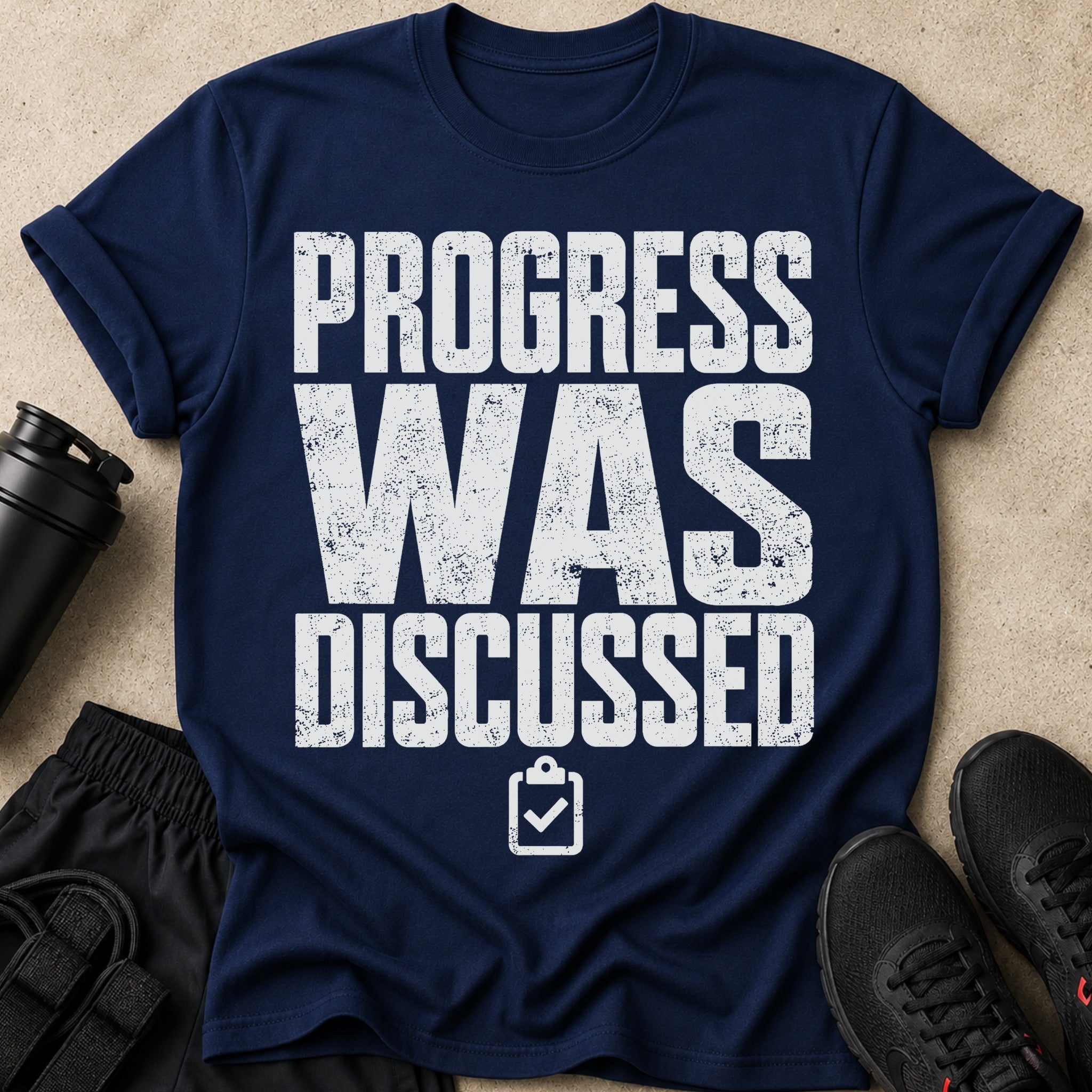 Navy t-shirt with "PROGRESS WAS DISCUSSED" and checklist graphic.