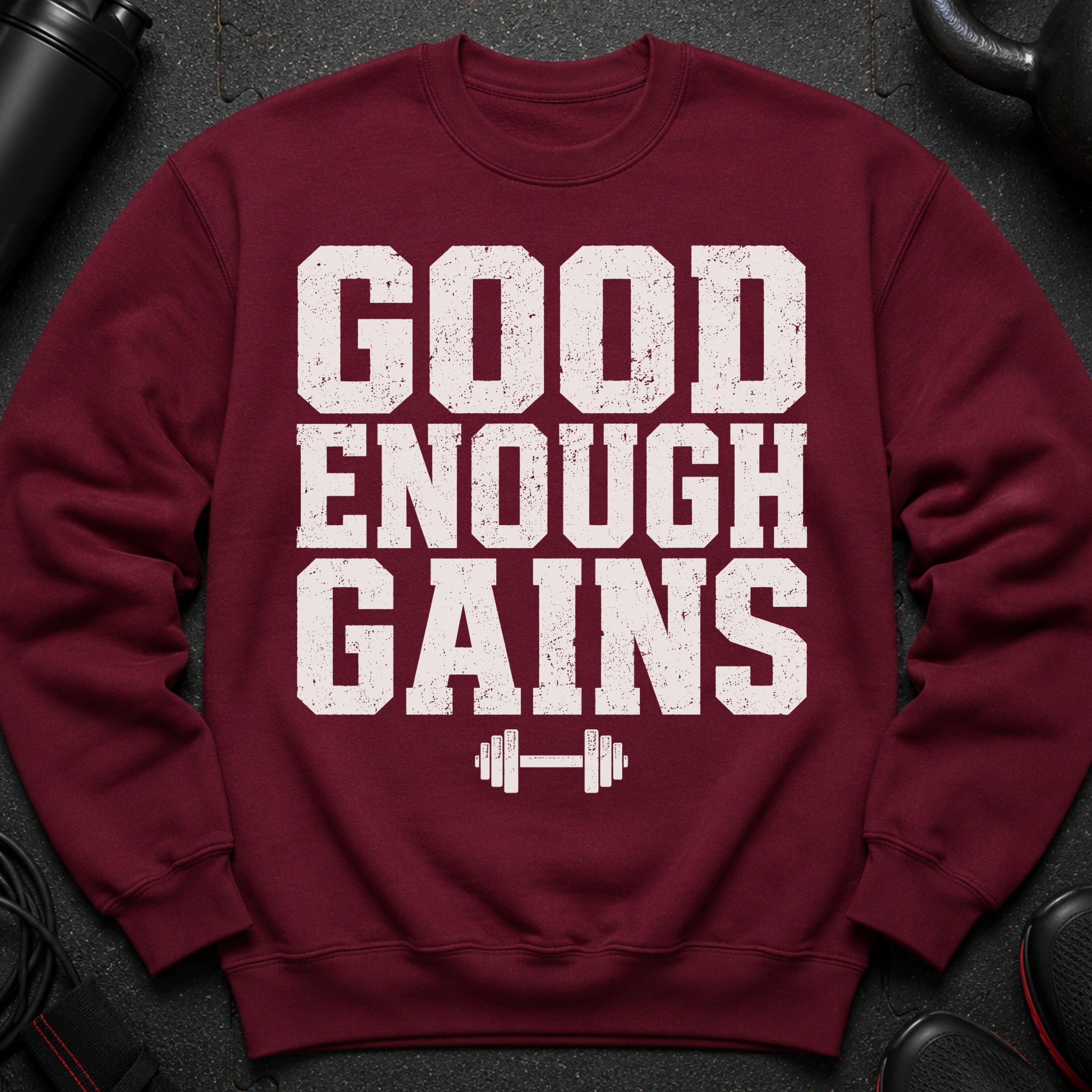 Maroon sweatshirt with white "GOOD ENOUGH GAINS" text and dumbbell graphic.