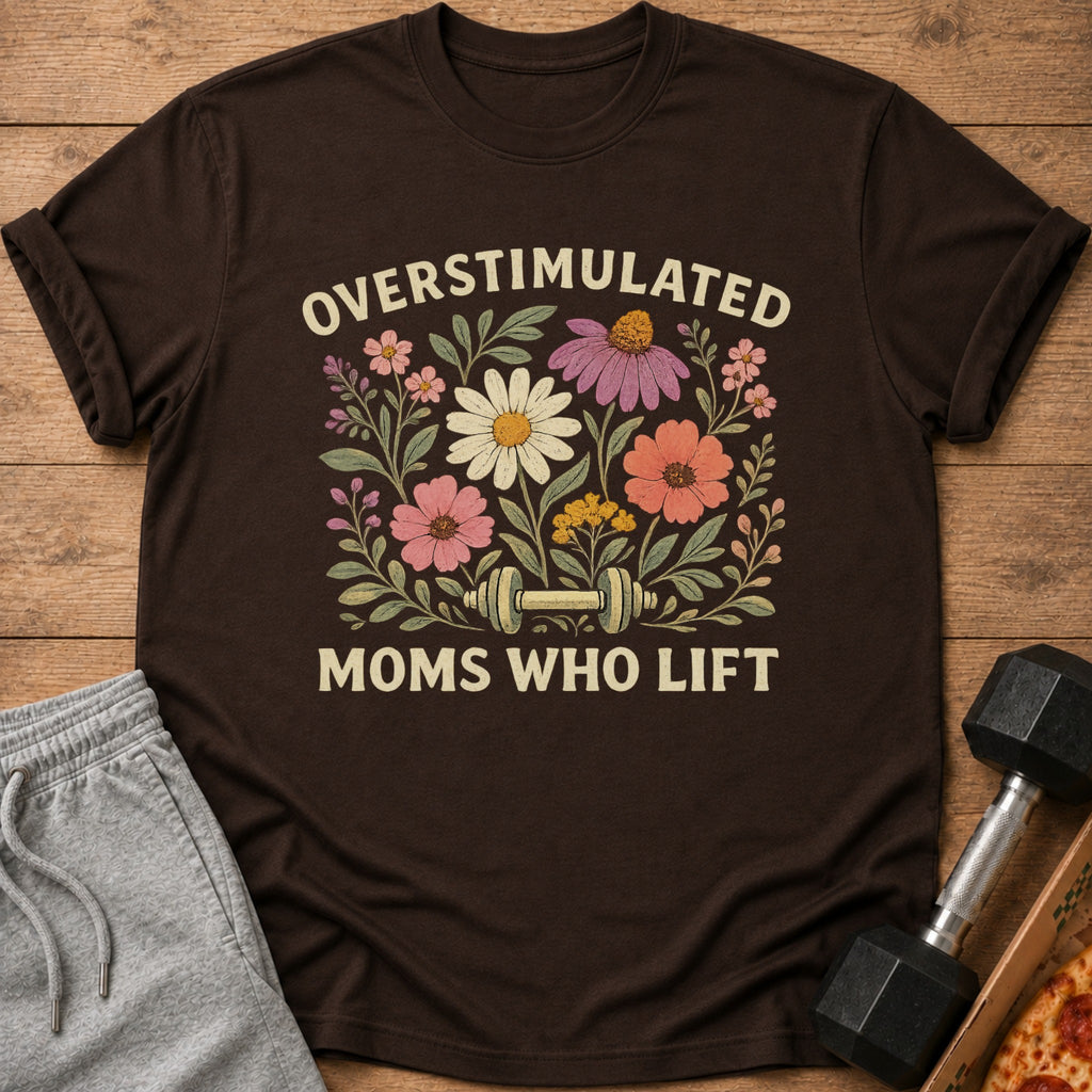 A brown t-shirt featuring floral graphics, a dumbbell, and the text Overstimulated Moms Who Lift.
