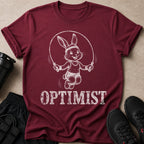 Maroon t-shirt with a jumping bunny graphic and the word OPTIMIST in white text.