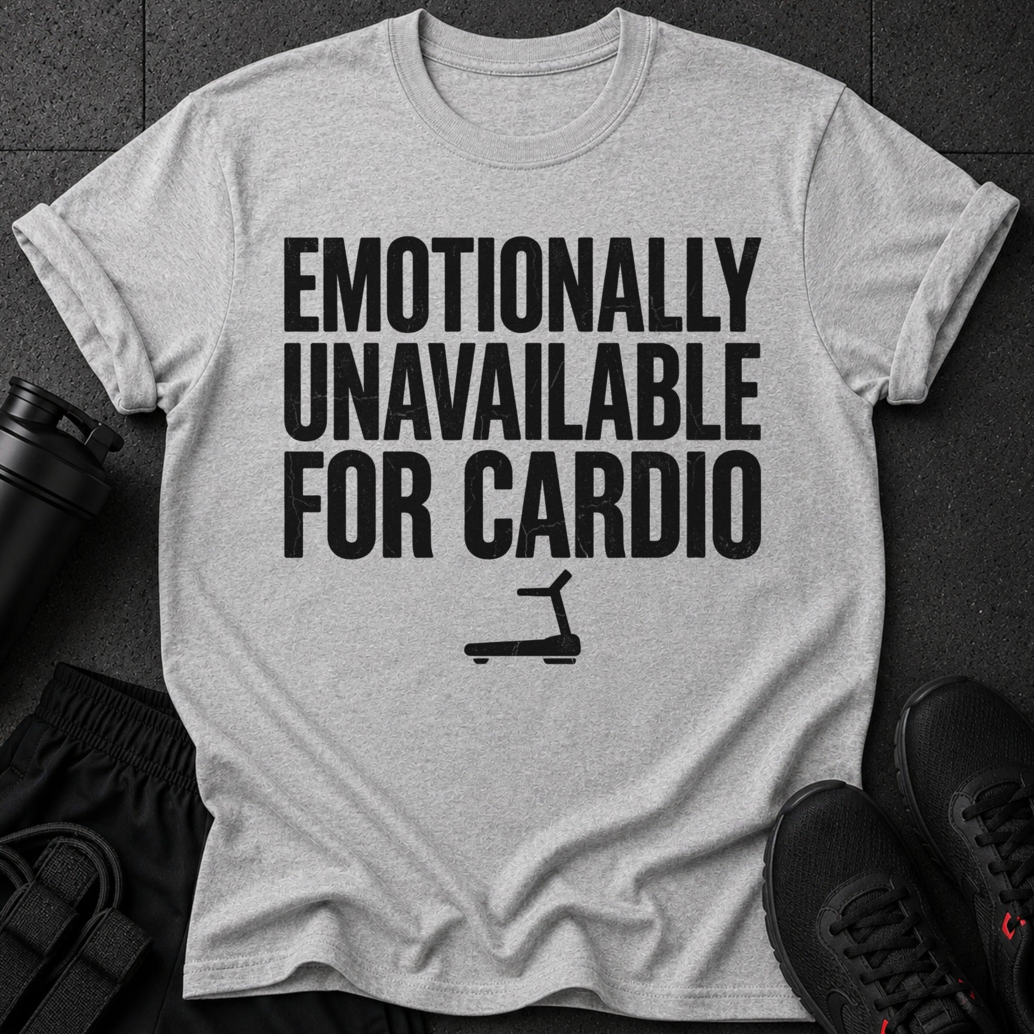 Gray t-shirt with black text "Emotionally Unavailable For Cardio" and a treadmill icon.