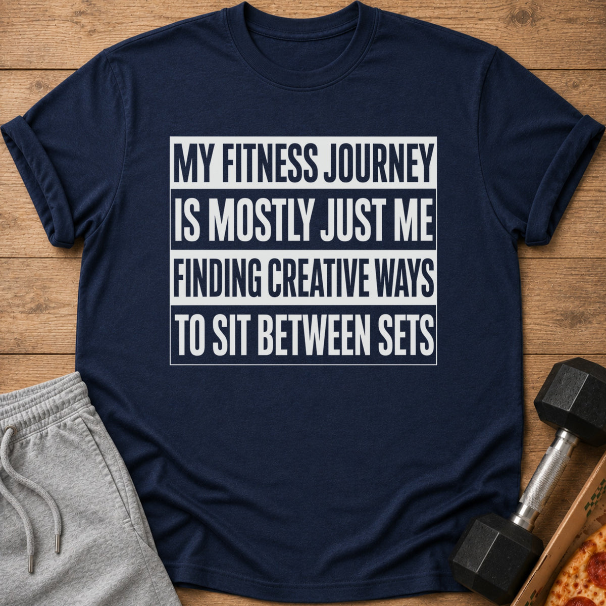 Navy t-shirt with white text "My fitness journey is mostly just me finding creative ways to sit between sets".