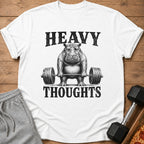 White t-shirt with a distressed graphic of a hippo lifting a barbell, reading "HEAVY THOUGHTS".
