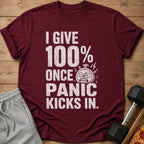 Maroon t-shirt with white text "I GIVE 100% ONCE PANIC KICKS IN." and a panicked stopwatch.