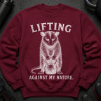 Maroon sweatshirt with distressed white graphic of an animal holding a kettlebell and text.