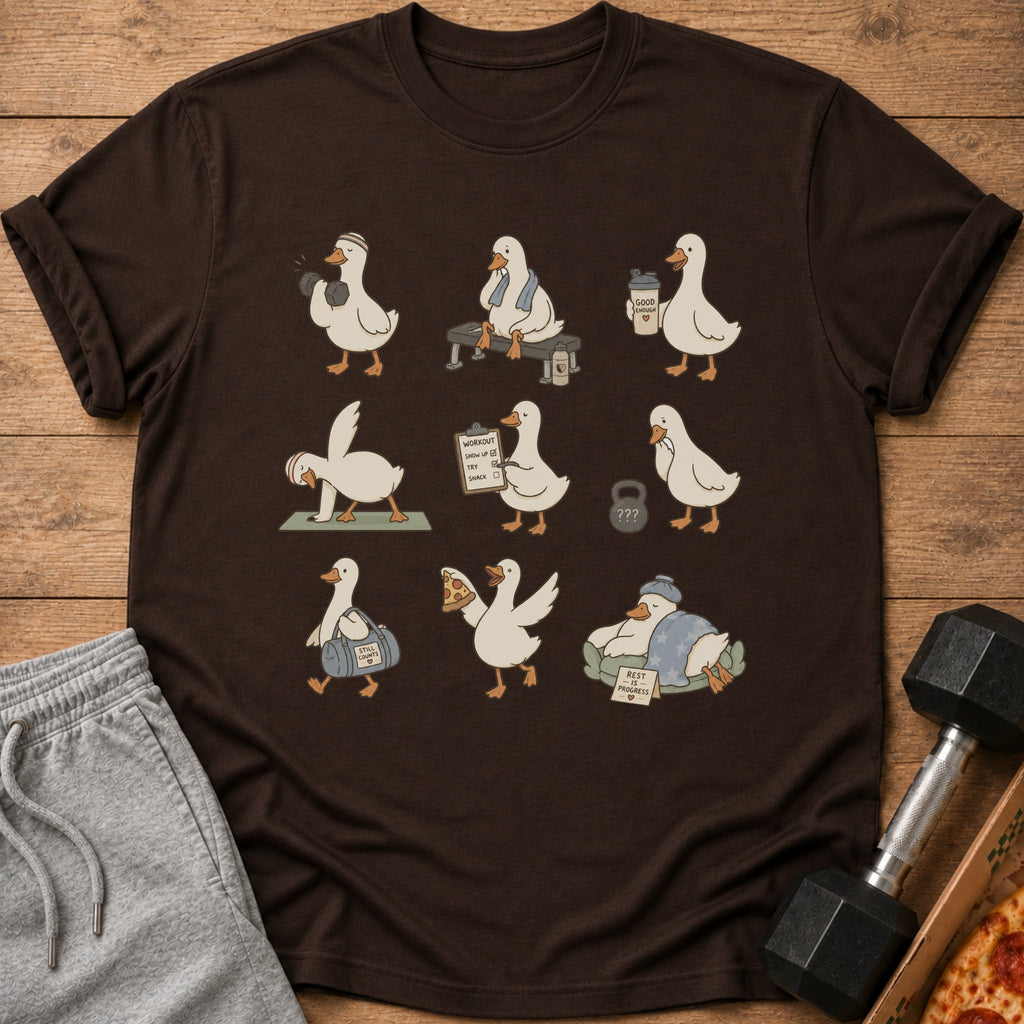 Brown t-shirt with a repeating pattern of cute cartoon ducks exercising and relaxing.
