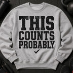 Grey sweatshirt with black distressed text "THIS COUNTS PROBABLY" and a checkmark.