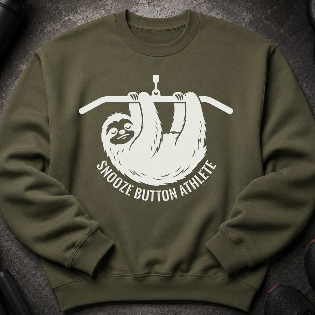 Green sweatshirt with white graphic of a sloth on a pull-up bar saying "Snooze Button Athlete".