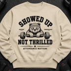 Crew neck sweatshirt with distressed print of a tired bear and barbell, reading "SHOWED UP NOT THRILLED".