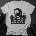Light gray t-shirt with a black graphic of a possum lifting weights and text.