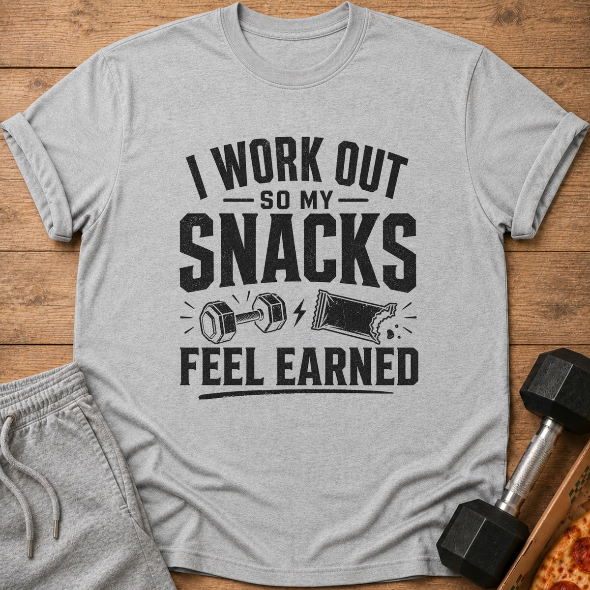 "I Work Out So My Snacks Feel Earned" graphic t-shirt with dumbbell and snack bar.