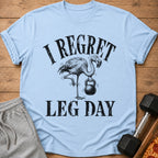 Light blue t-shirt with flamingo holding kettlebell and text "I REGRET LEG DAY".