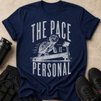 Navy t-shirt with a tortoise running on a treadmill and text "THE PACE IS PERSONAL".