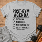 Grey t-shirt with "POST-GYM AGENDA" and a checklist including "SIT DOWN," "FIND FOOD," and "MENTION LEG DAY."