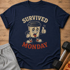 Navy t-shirt with cartoon coffee cup that says "Survived Monday"