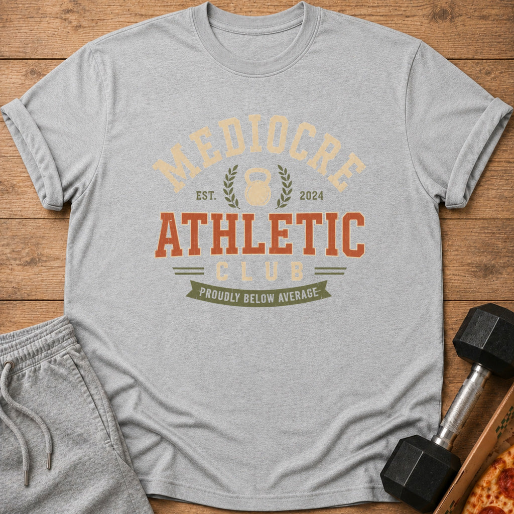 Grey t-shirt with "Mediocre Athletic Club" text and a kettlebell graphic.