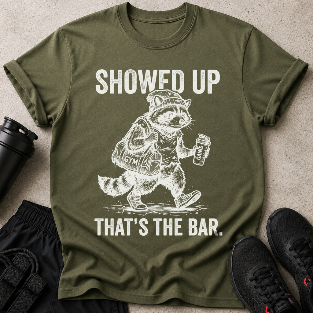 This t-shirt features a graphic of a raccoon with a gym bag and a protein shaker.