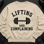 Light beige sweatshirt with black text "Lifting and Complaining" and a dumbbell graphic.