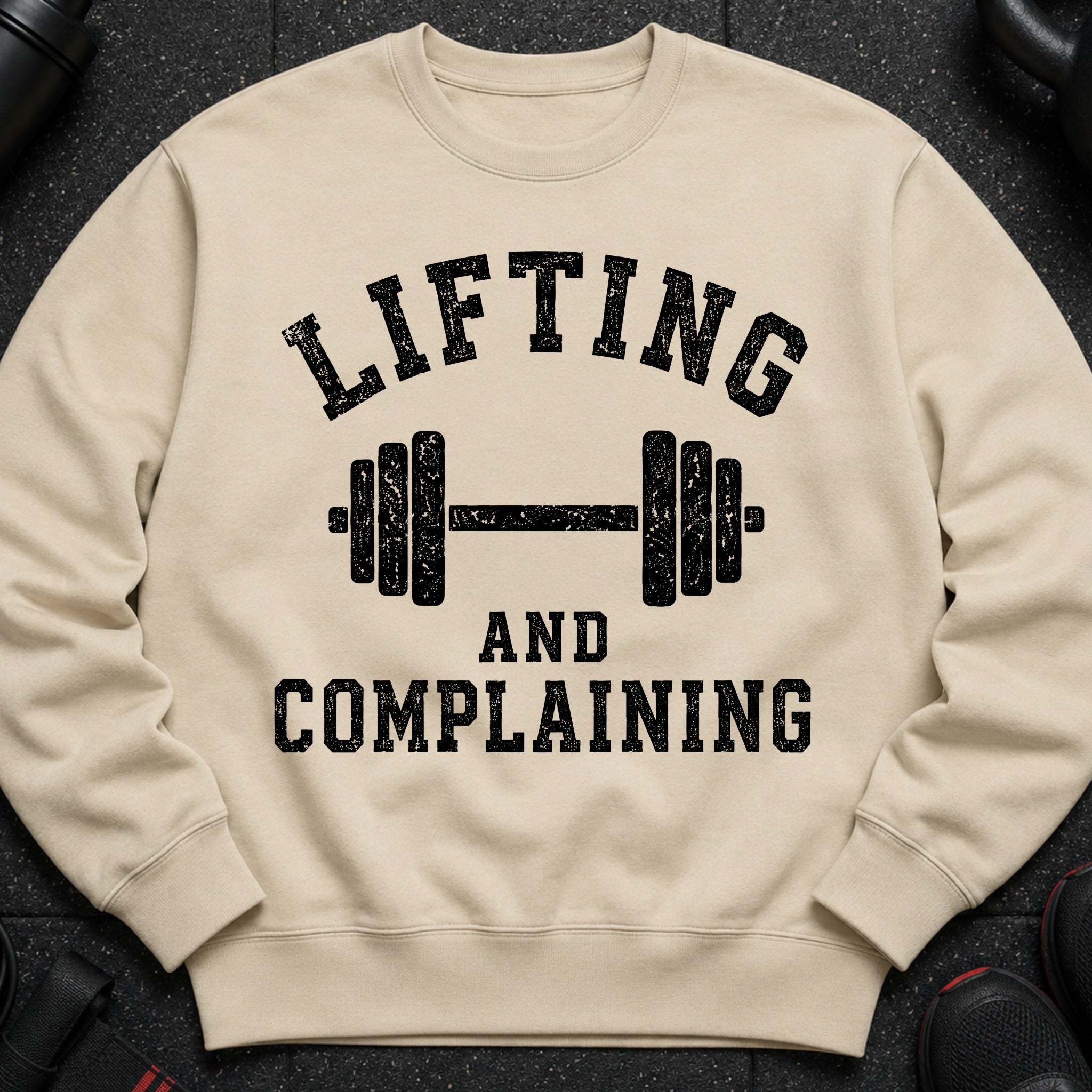 Light beige sweatshirt with black text "Lifting and Complaining" and a dumbbell graphic.