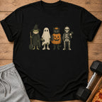 Black t-shirt with graphic of four costumed characters: frog wizard, ghost, pumpkin cat, and skeleton.