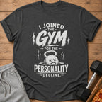 Dark gray t-shirt with text "I Joined the Gym for the Personality Decline" and distressed kettlebell.