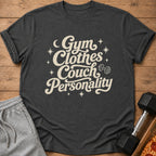 Dark grey t-shirt with text "Gym Clothes Couch Personality" and a dumbbell.