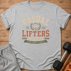 Grey t-shirt with "CASUAL LIFTERS SOCIETY" and "STRONG ENOUGH TO SHOW UP" graphic.