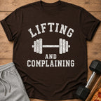 Brown t-shirt with distressed white text "LIFTING AND COMPLAINING" and a dumbbell graphic.
