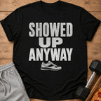 Black t-shirt with distressed white text "SHOWED UP ANYWAY" and a sneaker graphic.