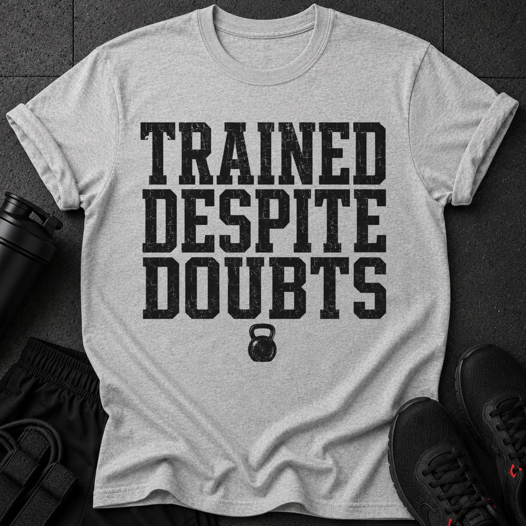 Grey t-shirt with black text "TRAINED DESPITE DOUBTS" and kettlebell graphic.