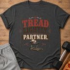 Dark gray t-shirt with "Tread Lightly, Partner." text and treadmill graphic.