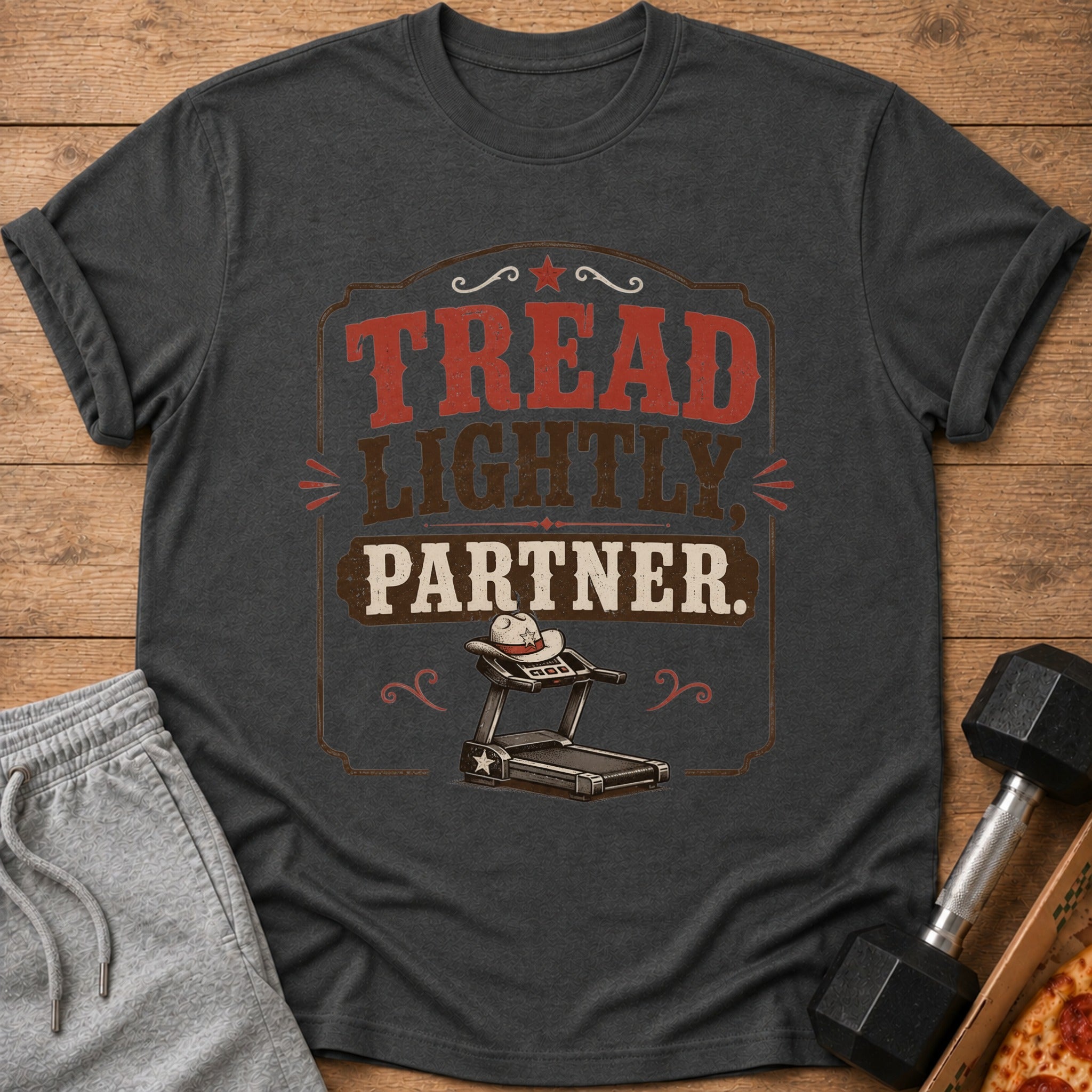 Dark gray t-shirt with "Tread Lightly, Partner." text and treadmill graphic.