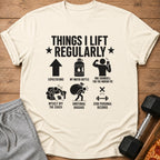 Shirt with text "Things I Lift Regularly" and humorous workout illustrations.