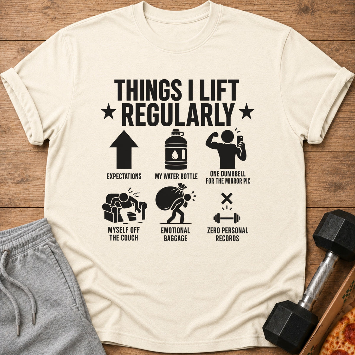 Shirt with text "Things I Lift Regularly" and humorous workout illustrations.