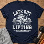 Navy t-shirt with a sloth on a barbell and text "LATE BUT LIFTING COUNTS THE SAME".