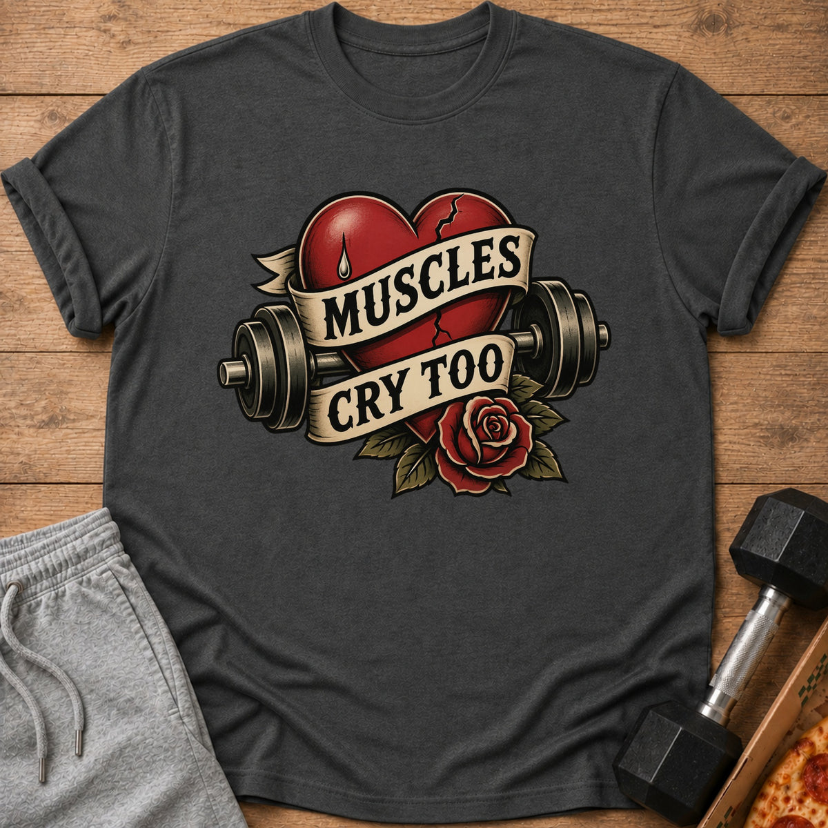 T-shirt with a broken heart, barbell, and rose graphic that reads "Muscles Cry Too".