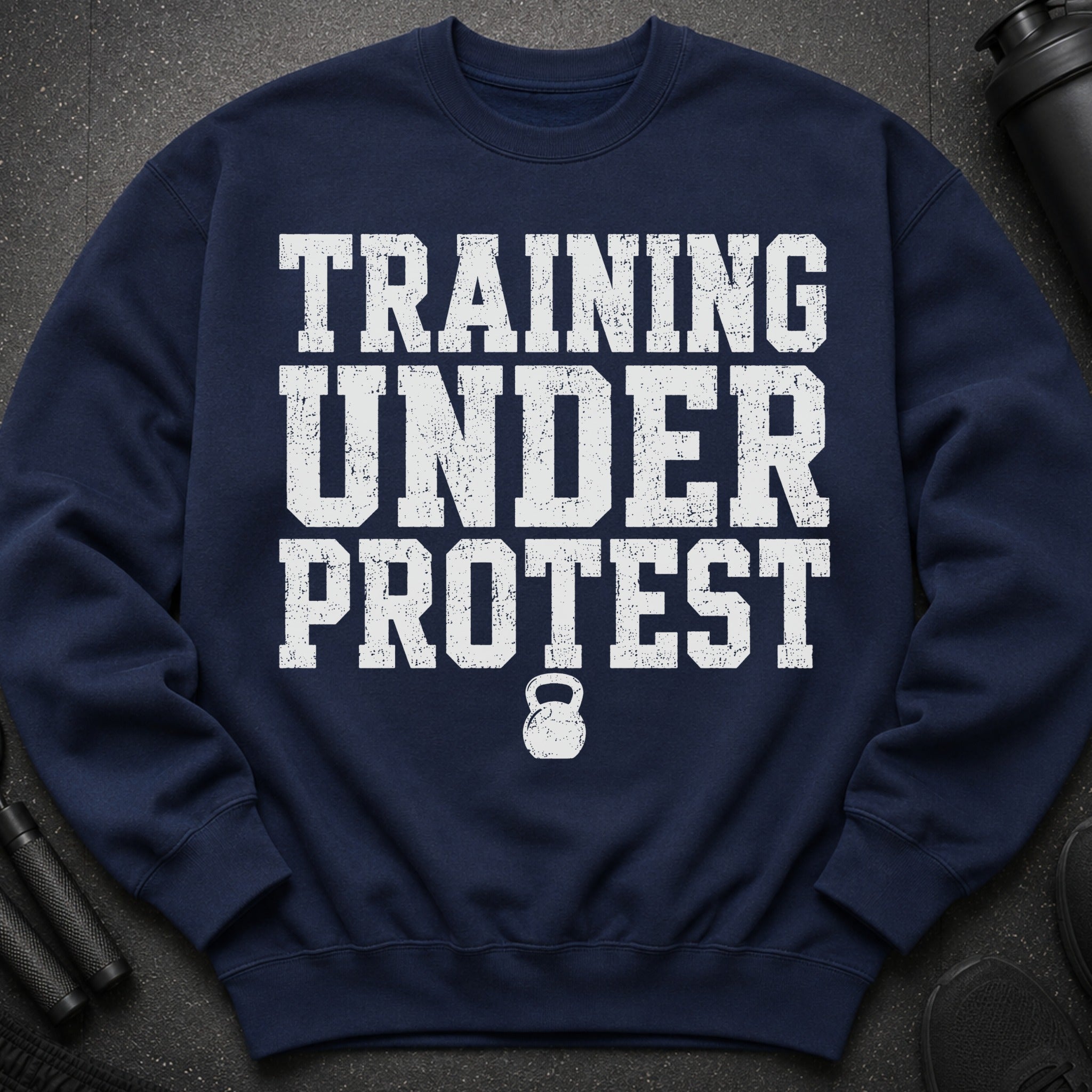 Navy sweatshirt with "TRAINING UNDER PROTEST" text and a kettlebell graphic.