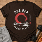 Brown t-shirt with white text "ONE REP INNER PEACE", barbell, and red circle graphic.