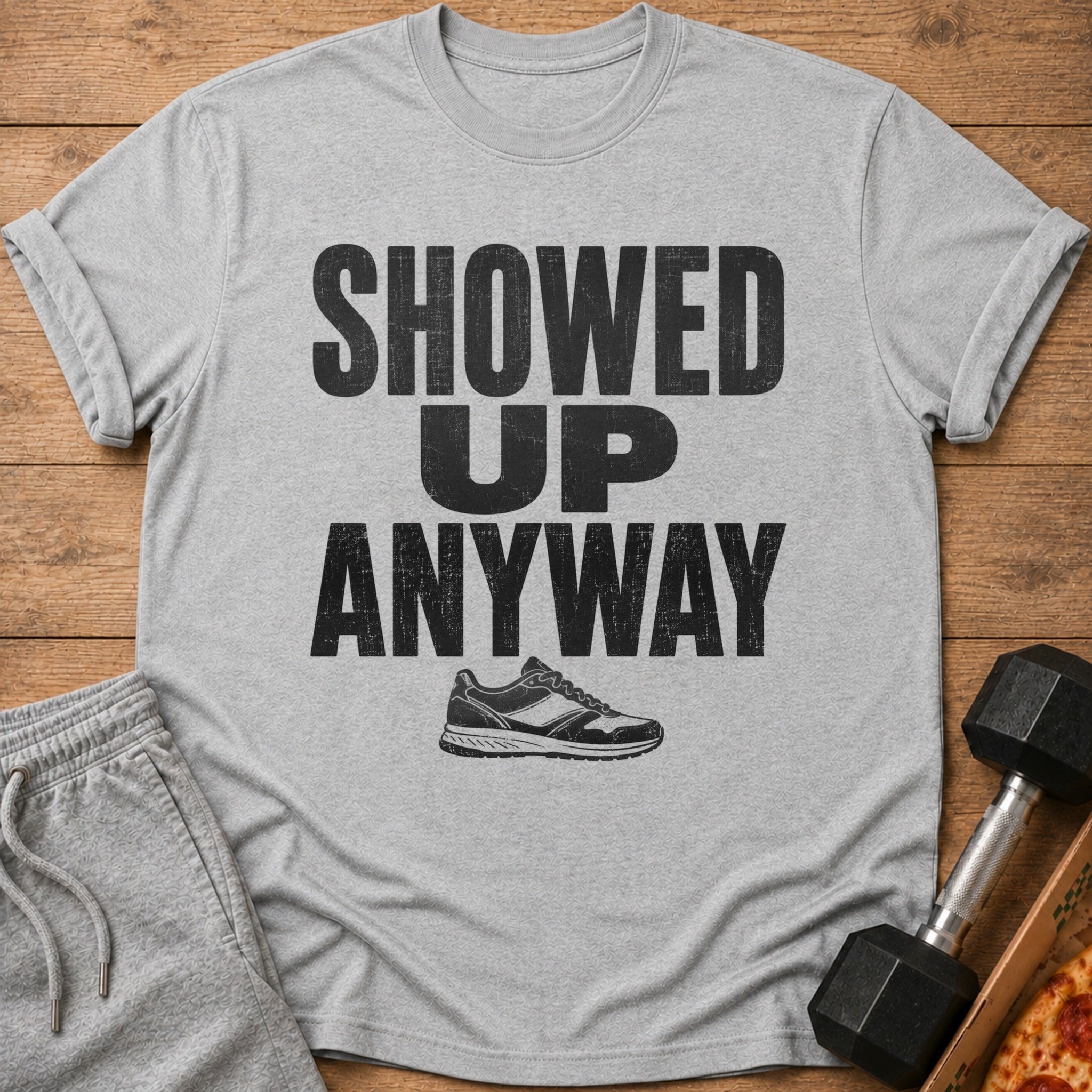 Gray t-shirt with "SHOWED UP ANYWAY" text and a sneaker graphic.