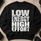 Black sweatshirt with distressed white text reading "LOW ENERGY HIGH EFFORT".