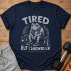 Navy t-shirt with graphic of tired frog on bench with weights and text "TIRED BUT I SHOWED UP."
