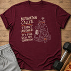Maroon t-shirt with cartoon cat on treadmill and text "Motivation called. I didn't answer. It's fine. We'll try tomorrow."
