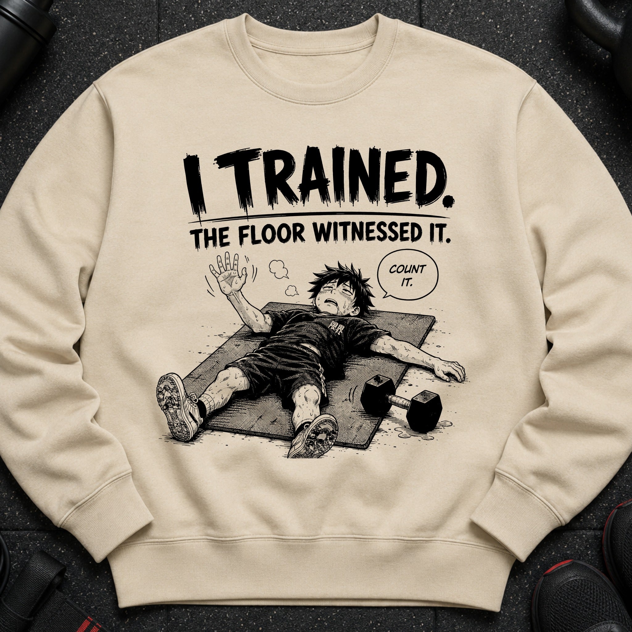 Light tan sweatshirt with black text "I TRAINED. THE FLOOR WITNESSED IT." and cartoon of exhausted person.