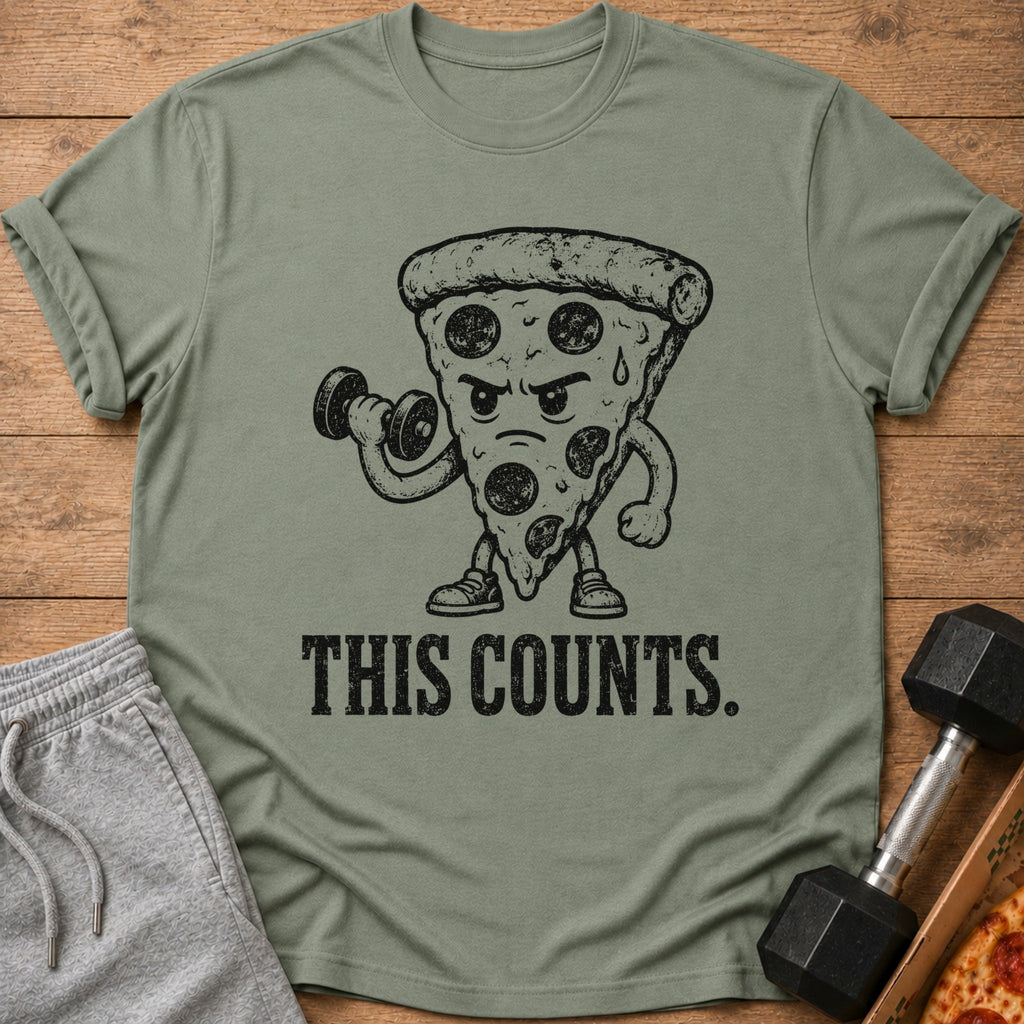 Green t-shirt with a cartoon slice of pepperoni pizza lifting a dumbbell and text "THIS COUNTS."
