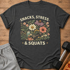 Dark gray t-shirt with "SNACKS, STRESS & SQUATS" and floral graphic.