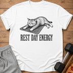 White t-shirt with a drawing of a cat on a mat and the text "REST DAY ENERGY".